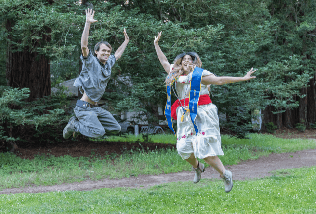 man and woman jumping for joy